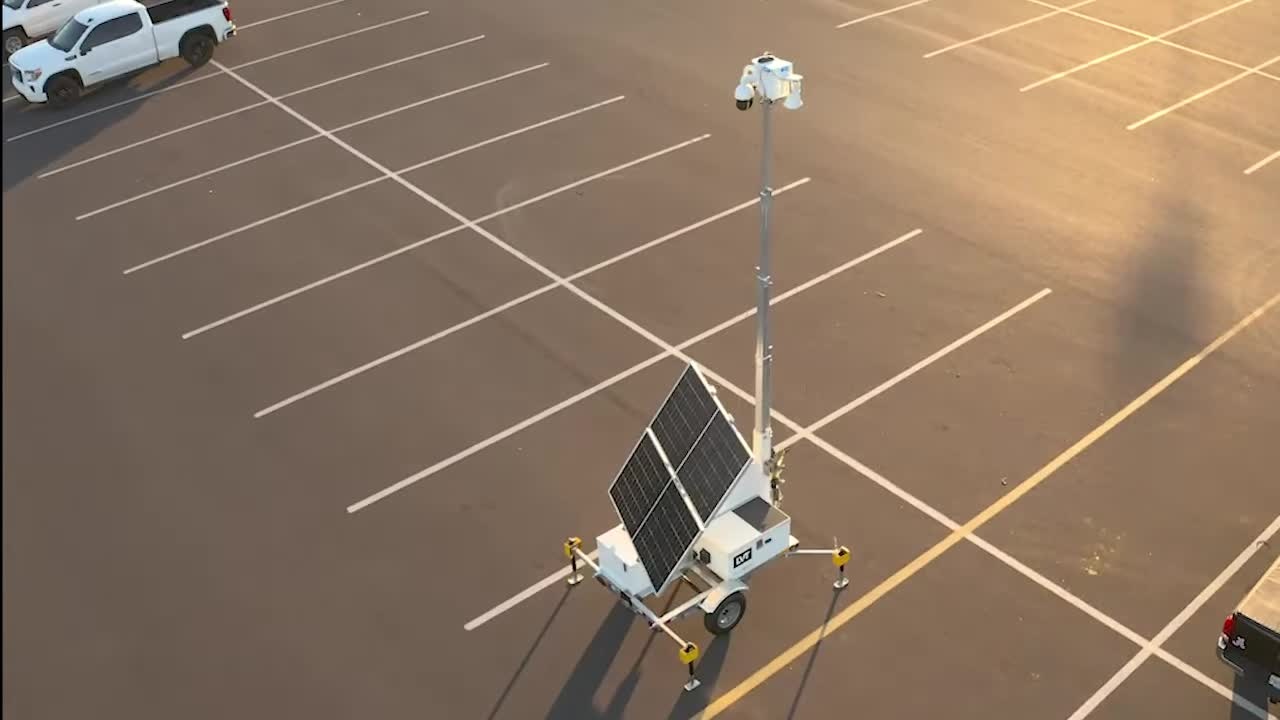 LVT security tower in a parking lot among vehicles